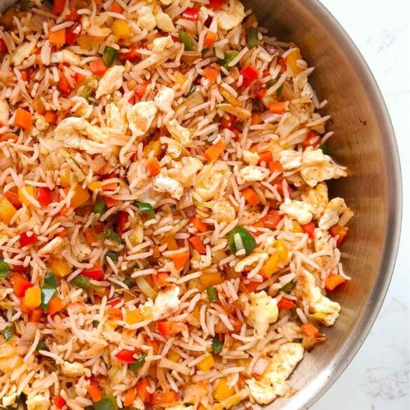 vegetable fried rice in a stainless steel pan