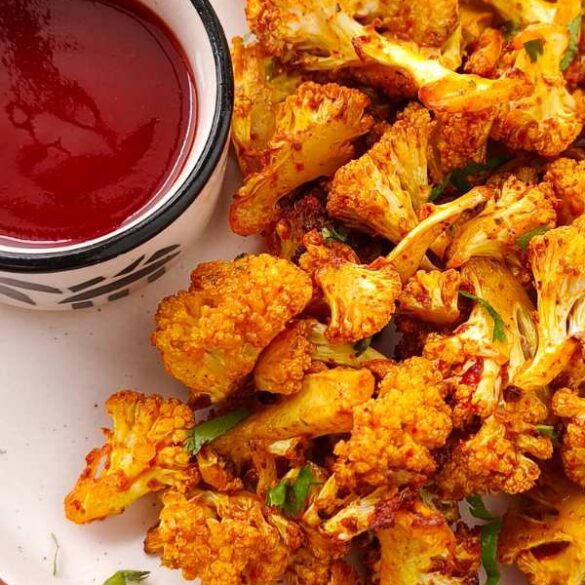 closeup air fryer roasted cauliflower with tomato sauce