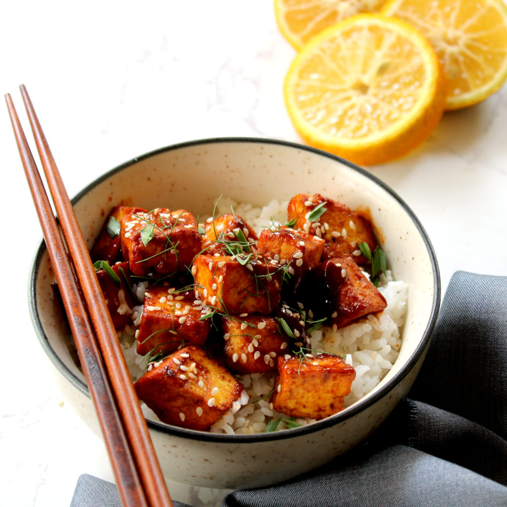 Baked orange tofu with sticky sesame sauce with a rice bowl