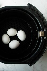 white eggs in balck air fryer basket
