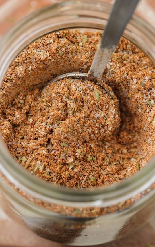 homemade fajita mix in a mason jar with a spoon