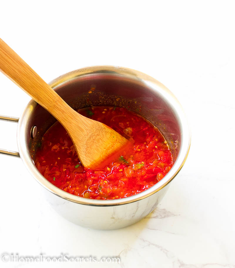easy homemade arribbata sauce recipe in a saucepan with a wodden spatula