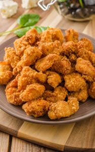 crispy deep fried chicken popcorn bites in a plate