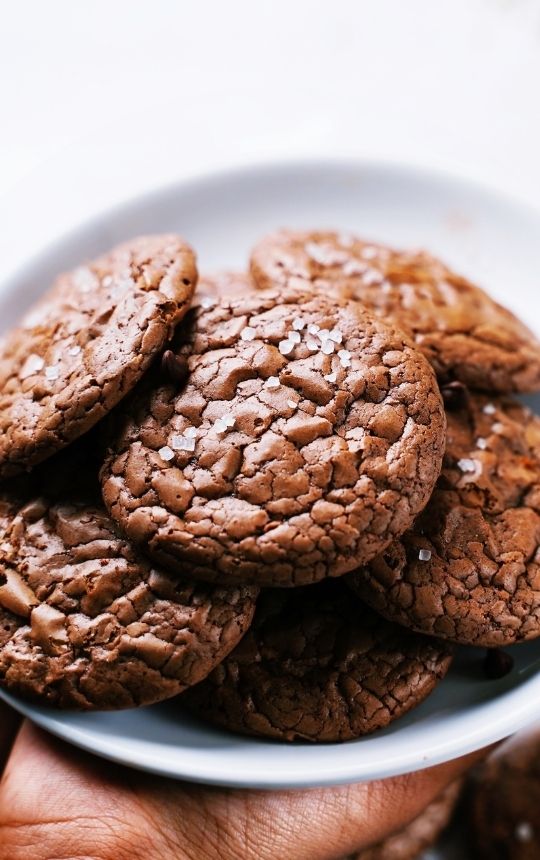 Stacks of brownie cookies on a white plate