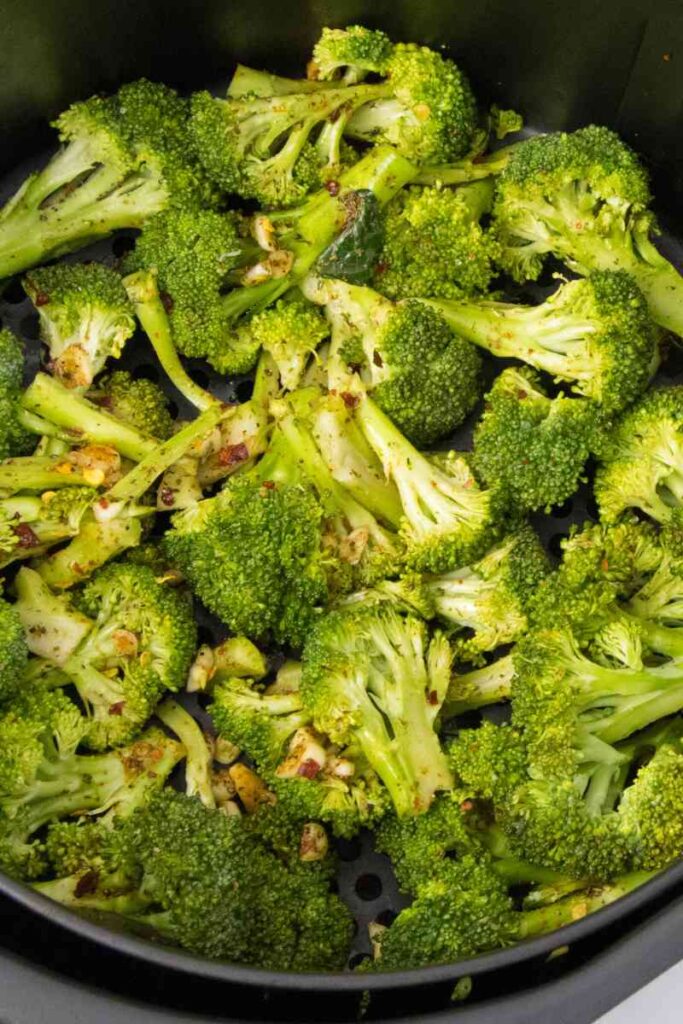 seasoned broccoli in air fryer basket