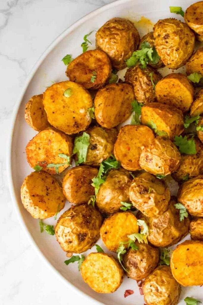 A close up of air fryer roasted baby potatoes one white plate