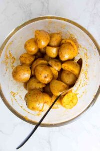a bowl of seasoned baby potatoes for air fryer roasted potatoes