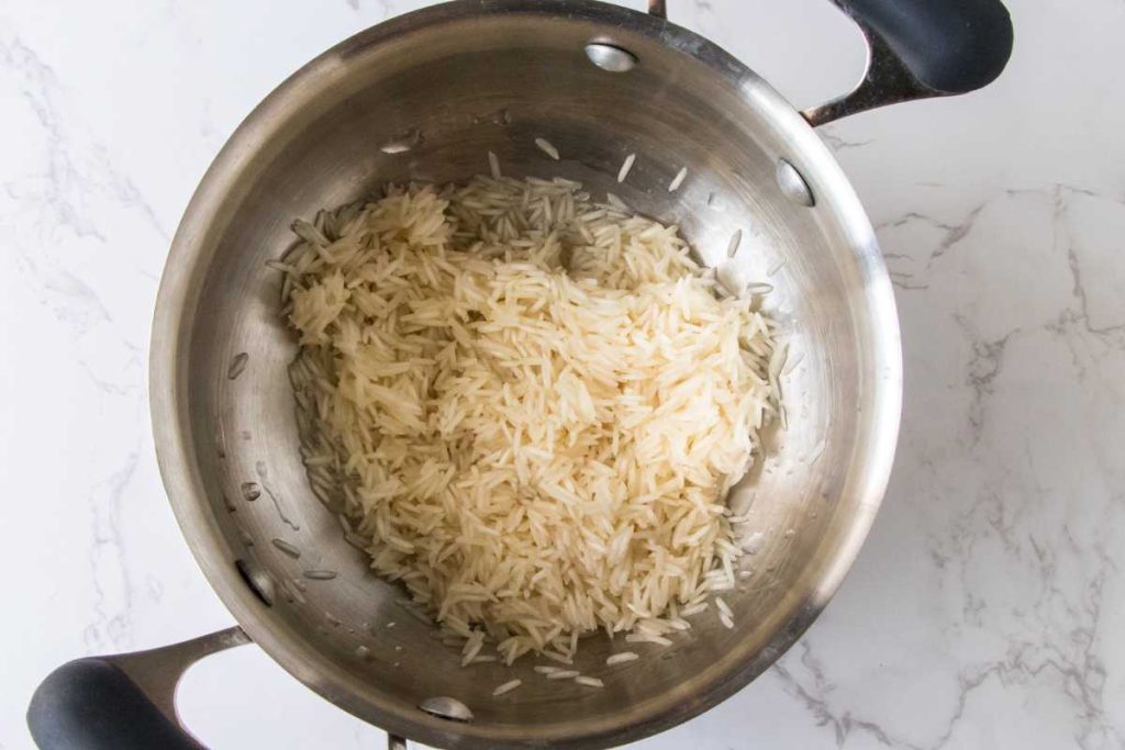Large pot filled with rinsed white rice