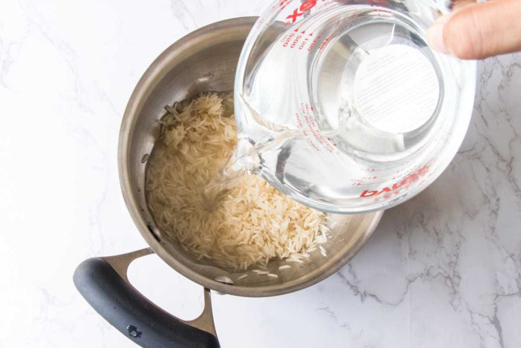 Large pot filled with white rice and water