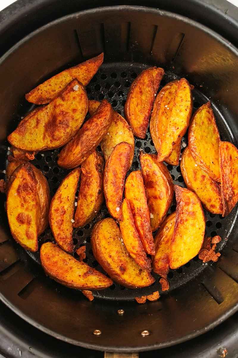 Air Fryer Potato Wedges cooked in an air fryer basket