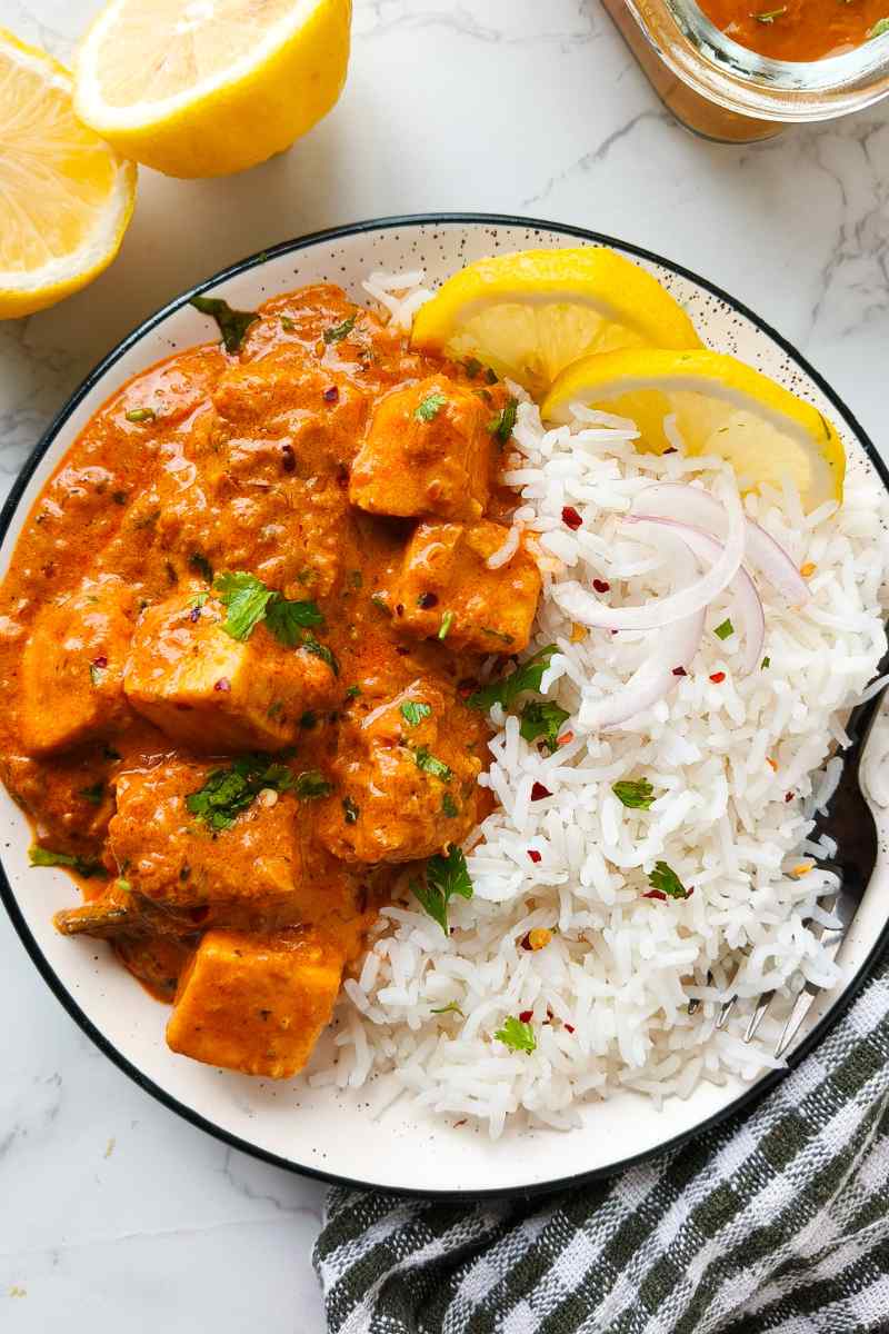 Vegan Butter Chicken and rice in a bowl with lemon