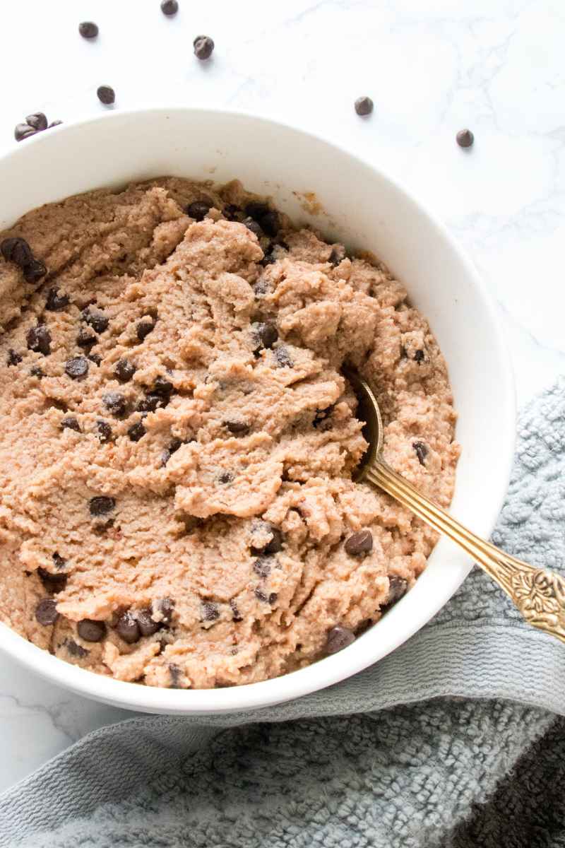 A golden spoon in a bowl of edible cottage cheese cookie dough